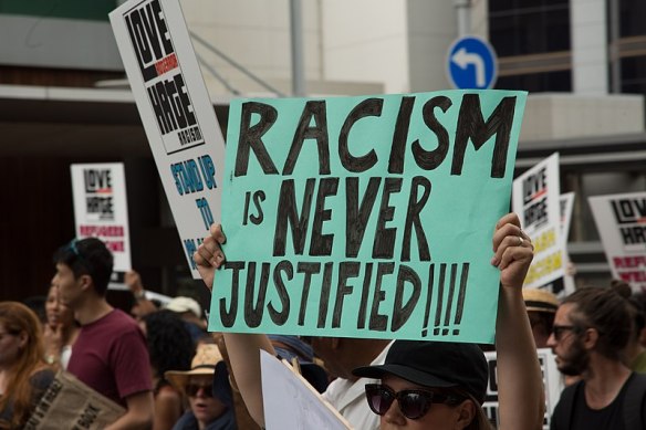 800px-Placard_Racism_is_Never_Justified